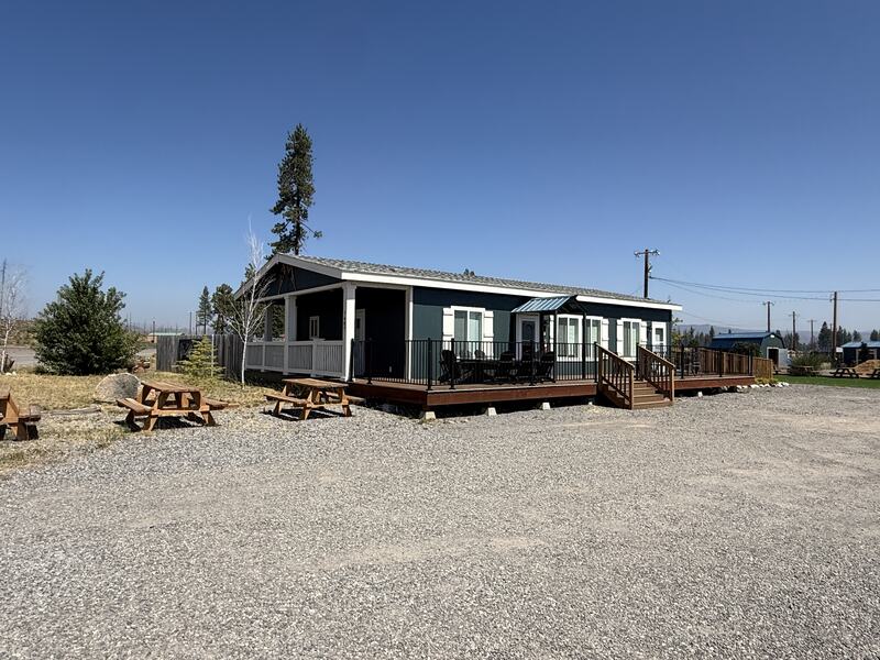 The house at Cedar Lodge with its covered porch and long railed deck.